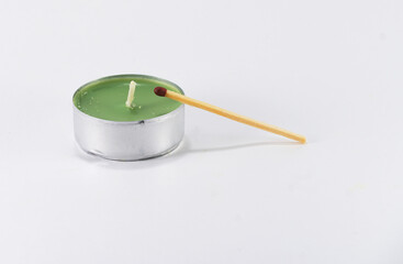 unlit colored candle with unlit match on white background