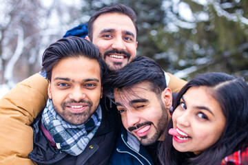 arabic guys having great time on Christmas holidays taking selfie photo on phone