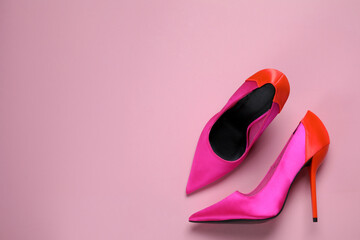 Pair of beautiful shoes on pink background, top view. Space for text