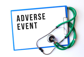 ADVERSE EVENT text on a medical folder and stethoscope on white background
