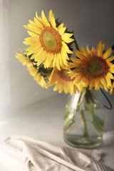Vase with beautiful yellow sunflowers on table
