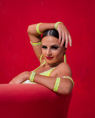 Ballroom Latin Dancer Posing in Front of a Red Background