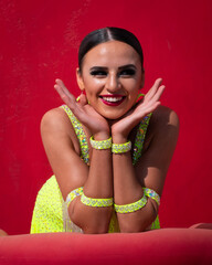 Ballroom Latin Dancer Posing in Front of a Red Background