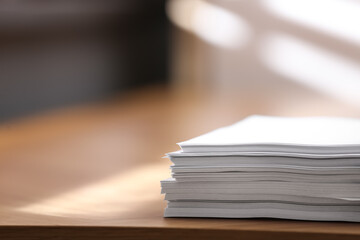 Stack of blank paper on wooden table indoors. Space for text