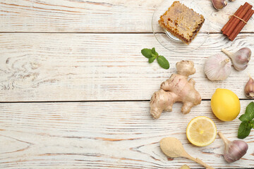 Flat lay composition with fresh products on light wooden table, space for text. Natural antibiotics