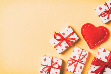 Top view of gift boxes and red textile hearts on colorful background. St Valentine's day concept with copy space