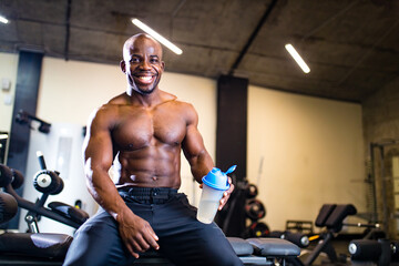 Fototapeta na wymiar attractive african hispanic athlete esting after training and drinking protein