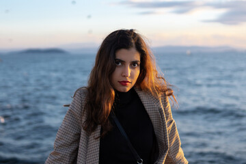 Portrait of a beautiful Arabic female model with a gorgeous hair at the beach