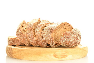 One half of a loaf of sliced, flavored buckwheat bread on a wooden tray, close-up, isolated on white.