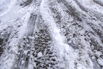 Fototapeta na wymiar Wheel marks on snowy road