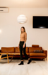Young woman walking through livingroom