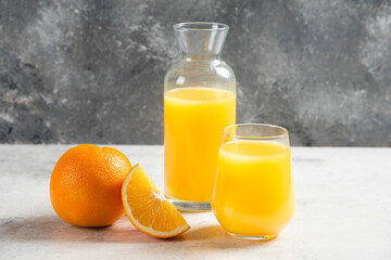 Fototapeta na wymiar A glass cups of fresh juice with slices of orange