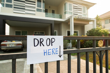 Drop Here sign for delivery man on the front gate in coronavirus covid-19 situation
