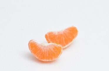 Two slices of tangerine on white isolated background