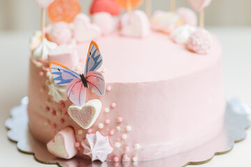 Pink cake with many decorations. Cake decorated with Marshmello