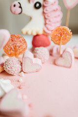 Pink cake with many decorations. Cake decorated with Marshmello