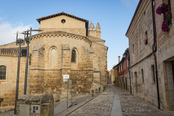 Fototapeta na wymiar a cobbled street passing by the church of St John in Castrojeriz village, province of Burgos, Castile and Leon, Spain