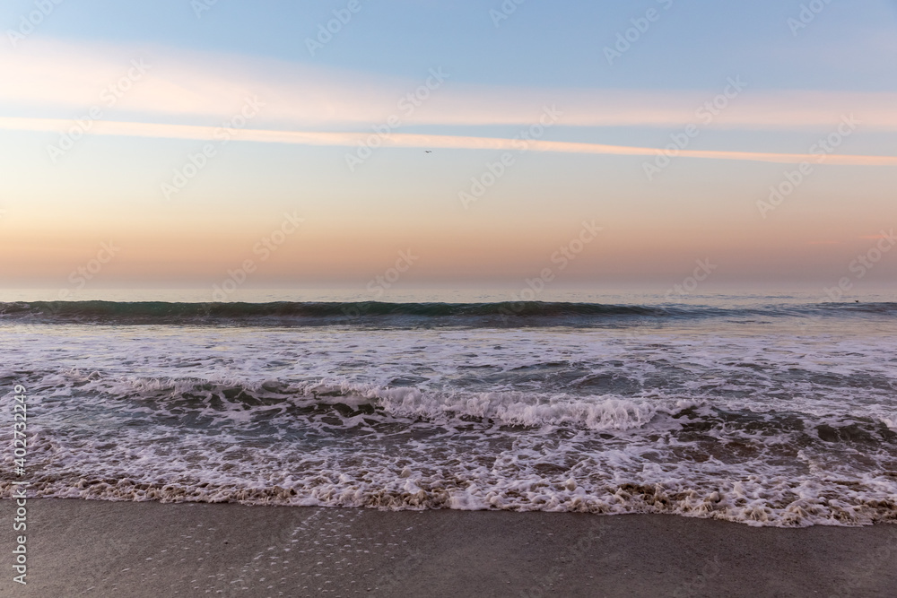 Canvas Prints Waves washing ashore in colorful sunrise at Malibu Beach, California