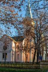 Naklejka premium Protestant church in the rays of the setting winter sun. Serbia, Pancevo, January 2, 2021