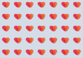 Seamless pattern of gummy hearts on light blue background