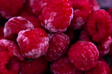 Frozen Raspberries in a Bowl placed on a black background