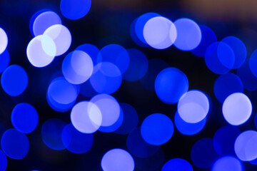 Blurred lights in background with bokeh in blue glitter
