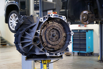 Automatic transmission (DSG) removed from vehicle for repair. In the background, the interior of a...