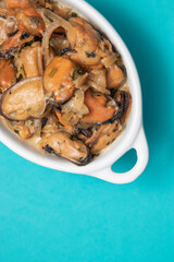 Mussels without shell slices in white ceramic bowl. Seafood concept. Selective focus. Space for text