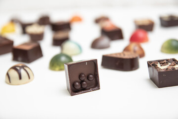 lot of variety chocolate pralines, top view of various chocolate pralines isolated on white background