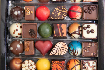 lot of variety chocolate pralines, top view of various chocolate pralines isolated on white background