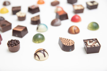 lot of variety chocolate pralines, top view of various chocolate pralines isolated on white background