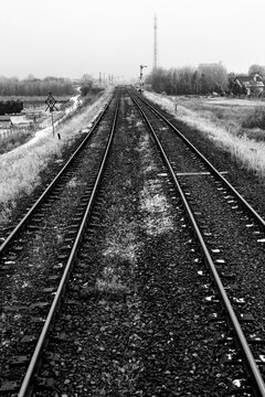 Two railroad tracks leading through the fields. Railway traction near the railway station.