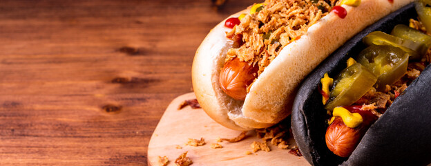 American traditional fast food Hotdog with fresh organic bread bun white wheat and black charcoal...