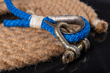 Wet shackle and rope. Accessories for sea wolves on the table. - obrazy, fototapety, plakaty