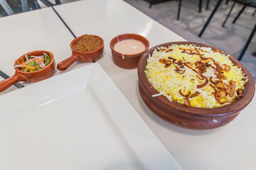 Biryani dish with several condiments