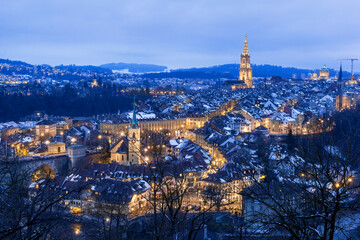 Old town of Bern in winter blue hour with snowy and illuminated buildings, Rosengarten, Bern, UNESCO, Switzerland