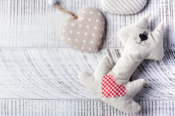 Valentine's Day background. Cat with heart on wooden background Copy space.