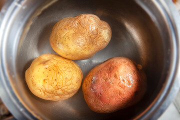 Three Potatoes in Water in Steel Pan