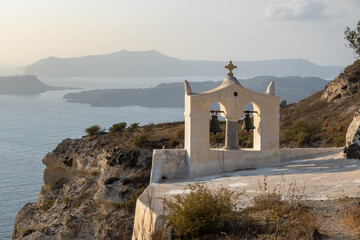 Church on the cliff and view of caldera on the island of Santorini, Greece