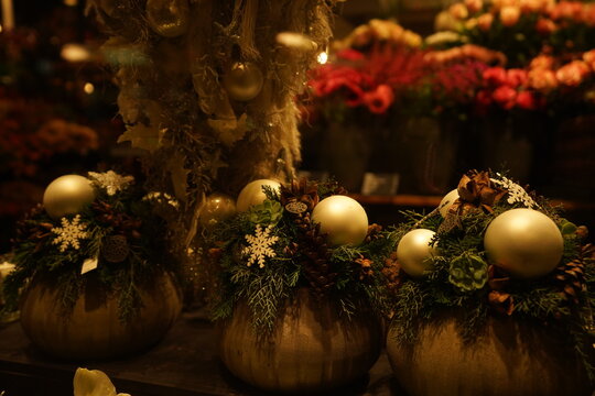 Illuminated showcase with flower bouquets, baubles and Christmas decoration in dark evening. Christmas window shopping at Paradeplatz in Zurich.