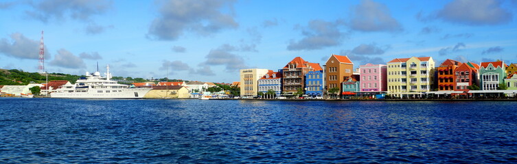 The panoramic view of the colorful buildings along the St Anna Bay during the day near Willemstad, Curacao 