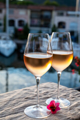 Tasting of local rose wine in summer with sail boats haven of Port Grimaud on background, Provence, France