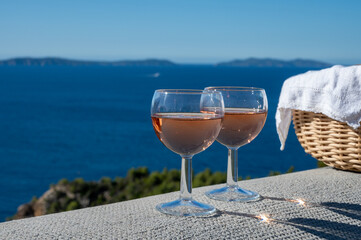 Picnic with of local rose wine and blue Mediterranean sea on background, near Saint-Tropez, Var, Provence, France