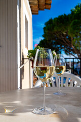 Tasting of local white wine on sunny summer balcony Provence, France