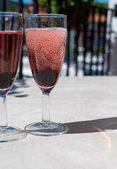 Summer party with sparkling rose champagne wine and sail boats haven of Port Grimaud on background, Provence, France