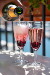 Summer party with sparkling rose champagne wine and sail boats haven of Port Grimaud on background, Provence, France
