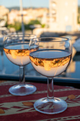 Drinking of local rose wine in summer with sail boats haven of Port Grimaud on background, Provence, France