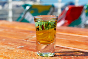 Tasting of very sweet french green strong liqueur based on many herbs, plants and flowers from Chartreuse abbey in Alpine mountains