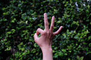 Someone's hand is giving a finger gesture OK, a sign of agreeing to something. In Japan this symbol is interpreted as something that involves money.