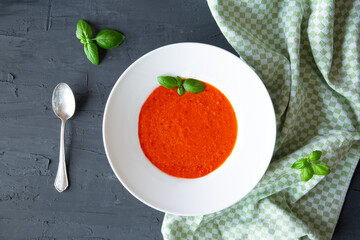 Cold gazpacho soup on black table, top view. Traditional spanish summer soup.